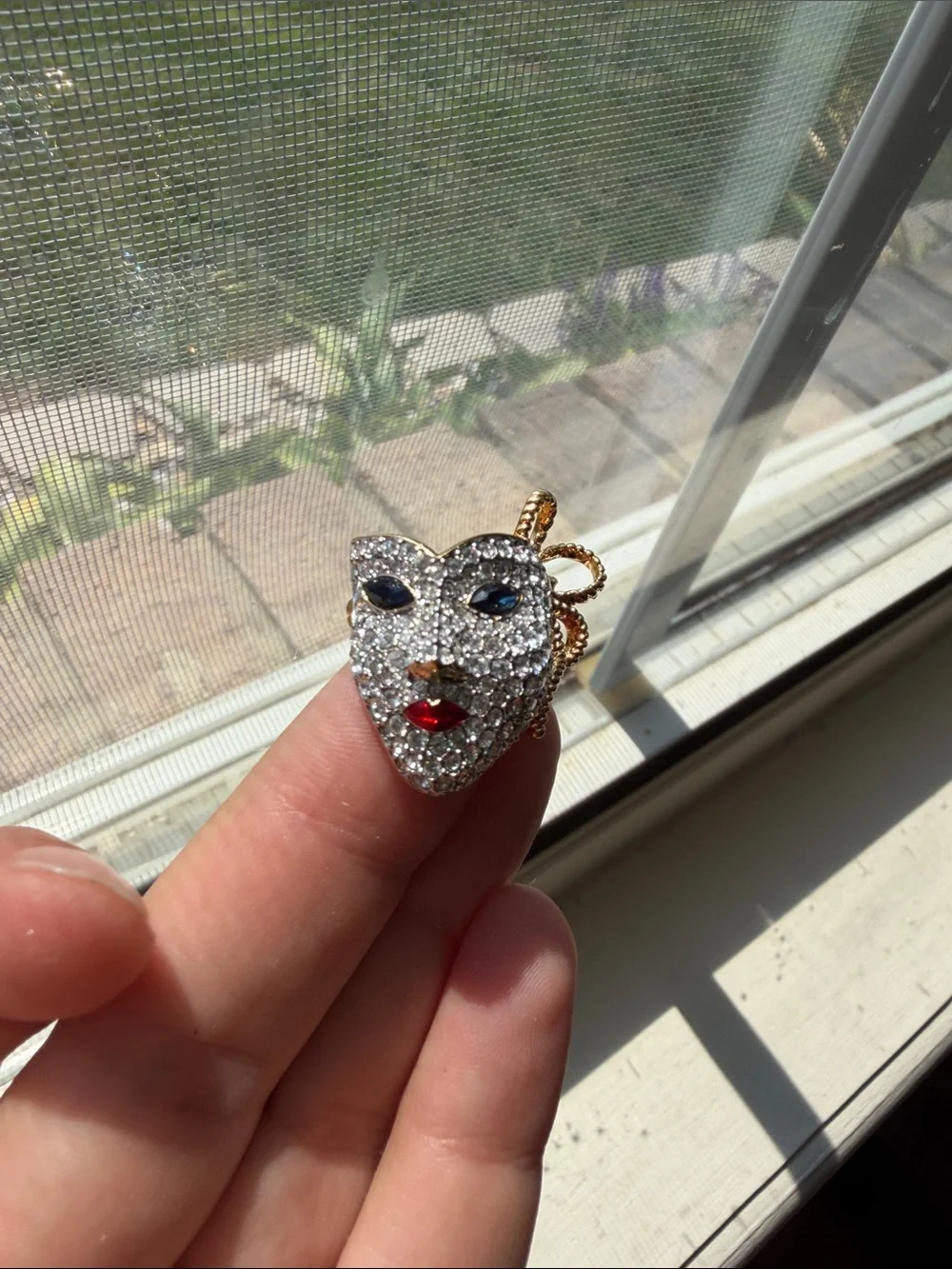 vintage 1990s Swarovski masquerade mask brooch features a pave-set crystal face